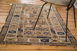 Distressed edge of antique Caucasian Kuba rug, with tattered fringe and indigo, ivory geometric borders.