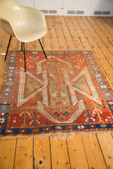 Distressed fringe and geometric border patterns on an antique Sewan Kazak rug.