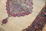 Distressed Kerman rug: faded rococo florals on a scalloped medallion with blue, red, ivory.