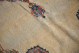 Distressed vintage Kerman rug with textured ivory cream field and cochineal red rococo motifs.