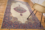 Distressed Kerman rug with faded floral medallion and milfleur border in muted tones. 4x7.