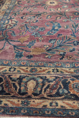 Plum and teal floral tendrils meet a Safavid border in navy, terra cotta.