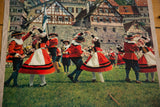 Traditional Salters' Dance performers in red, white, and black costumes at Schwabisch Hall.