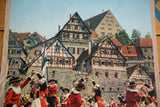Close-up of Salters' Dance performers in red costumes before German half-timbered houses.