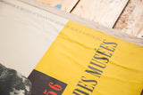 Creased yellow section of Mid Century Art Poster showing black text and red '56'.