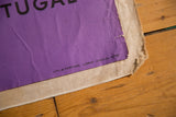Corner of vibrant purple 1961 poster, showing Portuguese text and linen mount.