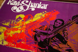 Ravi Shankar playing sitar, rendered in striking purple, black, and orange tones.