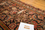 Distressed Northwest Persian runner with worn Herati floral pattern and exposed foundation.