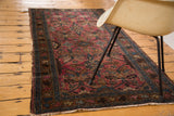 Vintage Lilihan runner's ruby rose field with serrated leaves, palmettes, and tattered side.