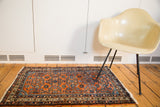 Vintage Persian Hamadan rug with allover Herati pattern in red rust, sky blue, and ivory.