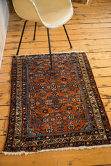 Vintage Hamadan rug's allover Herati field in red rust, sky blue, chocolate, and ivory.