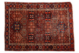 Antique distressed Baktiari rug, repeating cherry red, navy, saffron geometric panels, crab border.