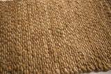 Natural golden-brown hand braided texture of the entrance mat.