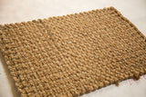 Textured, hand braided weave of natural hemp and jute fibers.