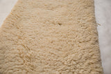 Plush cream Moroccan shag bath mat pile with soft, deep texture.