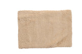 Hand woven Moroccan shag bath mat in plush light beige, measuring 2'2