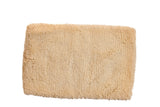 Hand woven Moroccan shag bath mat with plush, light beige texture, 2' x 3'1
