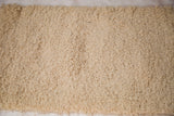 Close-up of plush, hand woven cream shag pile of the Moroccan bath mat.