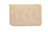 Plush hand-woven Moroccan shag bath mat in creamy beige, 2' x 3'.