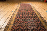 Antique Persian Malayer runner rug, circa 1920s, with repeating coral geometric motifs and golden borders.