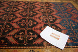 Intricate geometric design and time-softened hues of reddish-brown and deep blue on antique Malayer rug.