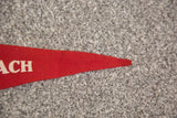 Close-up of the red felt King Philip banner's pointed tip with white 'ACH' letters.