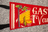 Red felt Gastown flag, depicting yellow building, Gassy Jack statue, and green tree.