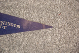 Pointed purple felt tip of the vintage Bennington VT flag banner, showing wear.