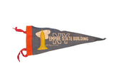 Vintage NYC Empire State Building felt flag in navy blue with golden yellow graphic and red ties.