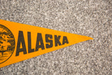 Pointed end of a vintage yellow felt Alaska banner with black 