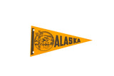 Vintage orange felt Alaska pennant with black totem pole and ship design.
