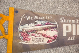Detail of vintage Pikes Peak felt flag showing 'Summit House' graphic, yellow trim.