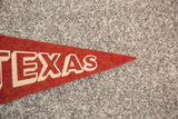 Vintage Texas felt pennant detail, cream 'EXAS' letters on rust-orange.