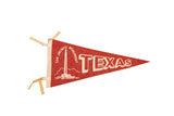 Vintage red felt Texas San Jacinto Monument pennant with off-white graphic and text, 6x12 inches.