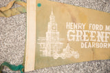 White printed building, vintage vehicle, and Dearborn text on aged green felt flag.