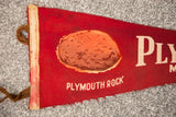 Vintage red felt Plymouth Rock banner detail, featuring 1620 graphic and worn off-white edge.