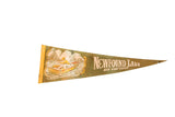 Vintage olive green Newfound Lake felt pennant with fishing scene and golden lettering.