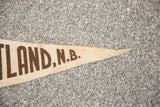 Vintage Hartland N.B. felt flag banner's pointed end, showing brown text and texture.