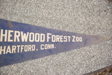 Pointed tip of vintage Sherwood Forest Zoo felt flag with text and age-related wear.