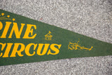 Close-up of the yellow graphics and lettering on the green felt Shrine Circus flag.