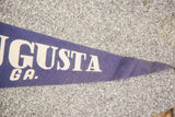 Close-up of vintage purple felt Augusta GA banner, highlighting white letters and aged texture.