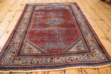 Mir Serbend rug lower corner, highlighting time-worn red rust field and geometric border.