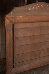 Detail of the aged, hinged side and slatted front of the Kiwanis wooden display.