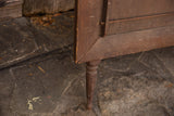 Vintage Kiwanis wooden display with a carved leg and distressed dark brown wood texture.