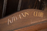 Mid-century Kiwanis Club hand-painted gold lettering on carved dark wood display.