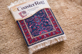 Coaster Oriental Rug with deep blue field, ruby red palmette and vine motifs, white fringe.