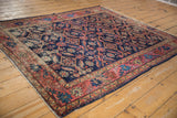 Distressed Malayer rug: Herati lattice with serrated leaves, blush red, indigo, and saffron.