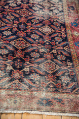Antique Malayer rug's fringe, with decorative distressed texture in blush red and indigo.