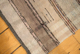 Vintage Scandinavian rag rug's hand woven striped texture and visible interior tatter.