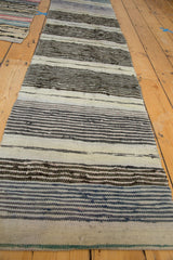 Hand-woven Scandinavian rag rug texture with ivory, charcoal, and blue stripes.